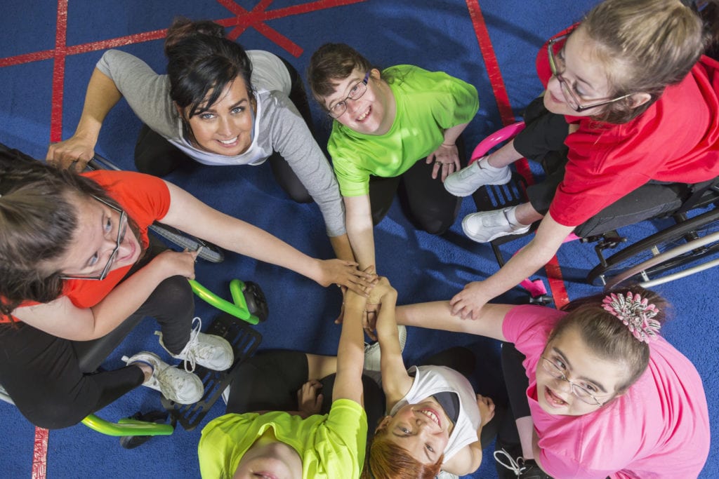 Group of special needs girls showing team spirit