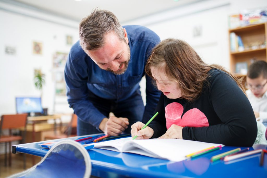 Teen girl with down syndrome learning