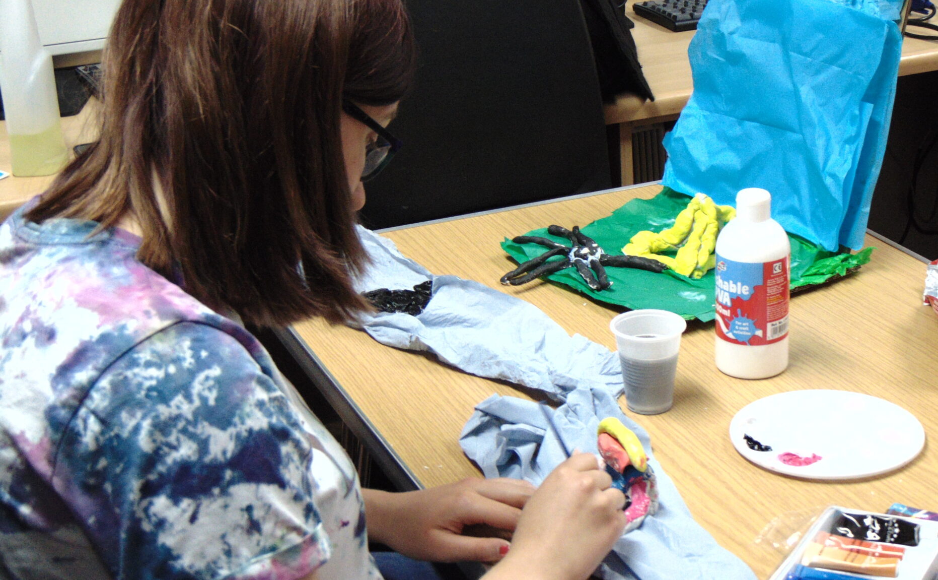 Talkback Member making props out of clay