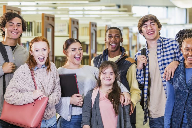 High school students in library, girl with down syndrome